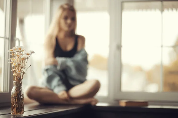 Young woman on windowsill — Stock Photo, Image