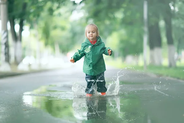 Little girl in rainy park — Stock Photo, Image