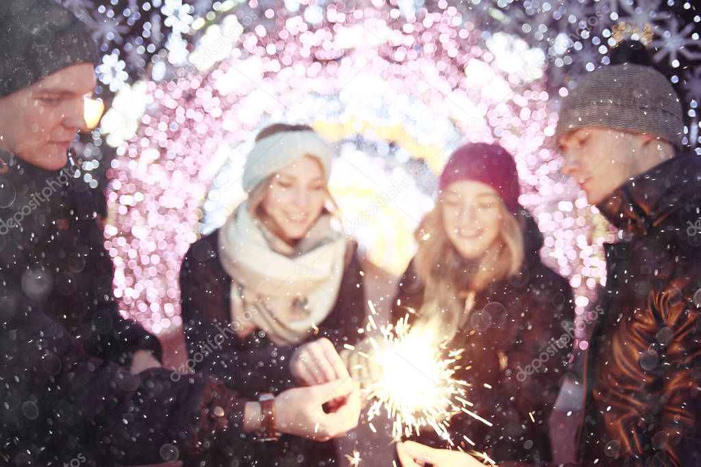 people with sparklers celebrating Christmas