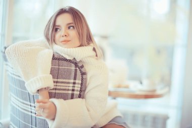 Parlak bir kafede sabah kahvaltısı, genç bir mankenin samimi bir portresi, evde yaşam tarzı.