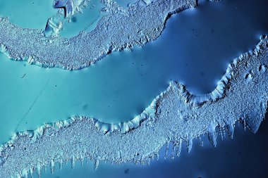 Mavi buzlu cam arka plan, buzun yüzeyinin soyut dokusu, donmuş mevsimlik su.