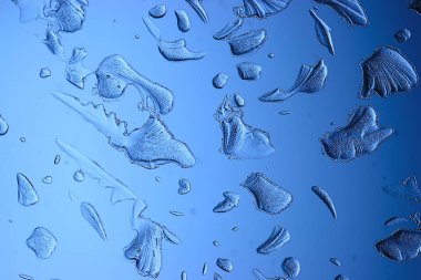 Mavi buzlu cam arka plan, buzun yüzeyinin soyut dokusu, donmuş mevsimlik su.