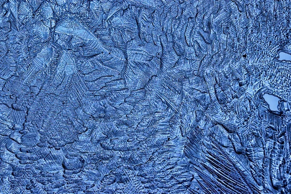 blue ice glass background, abstract texture of the surface of the ice on the glass, frozen seasonal water