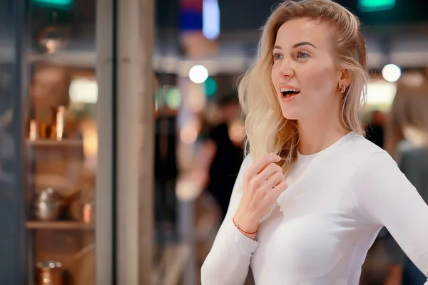 girl in the market, young adult model posing in the market, in the store with purchases