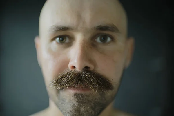 unusual portrait of a bald mustachioed young gentleman, eccentric mister, psychology concept