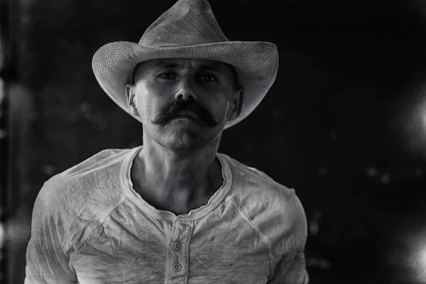 stylized vintage portrait of a man wild west, mustachioed dangerous criminal, mustache on his face