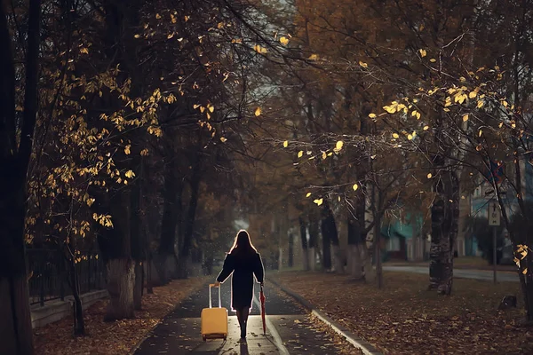 autumn evening woman holds umbrella, october in dark city park, young lonely model with umbrella