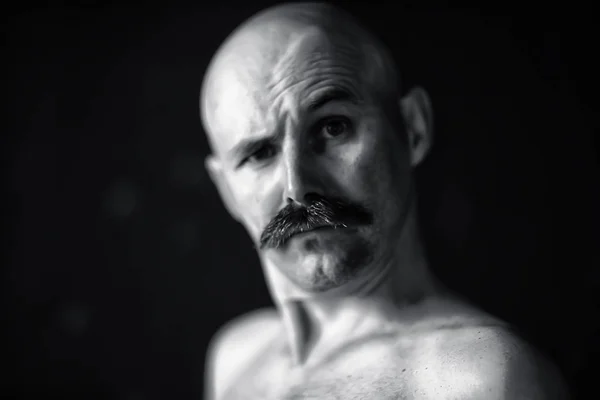 unusual portrait of a bald mustachioed young gentleman, eccentric mister, psychology concept