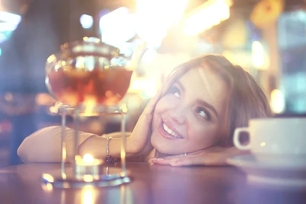 young model drinks tea in a cafe, vacation concept table setting