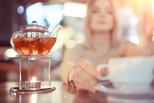 young model drinks tea in a cafe, vacation concept table setting