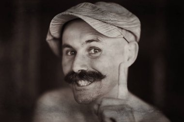 Bıyıklı neşeli kel adam, gülümseyen, poz veren, bıyıklı genç bir adamın portresi.