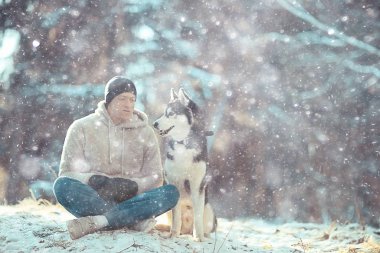 Köpekli bir adam kış ormanlarında yürüyüşe çıkıyor, güneşli bir Noel manzarası, parkta yaşayan insanlar ve köpekler.
