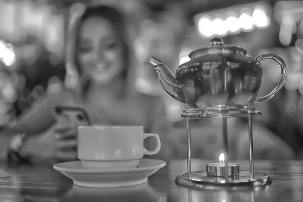 young model drinks tea in a cafe, vacation concept table setting