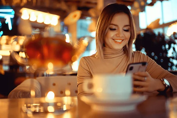 young model drinks tea in a cafe, vacation concept table setting