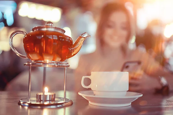 young model drinks tea in a cafe, vacation concept table setting