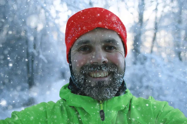 beard in hoarfrost, portrait of a young bearded guy, seasonal outdoor activities in winter in Scandinavia, Norwegian adventure