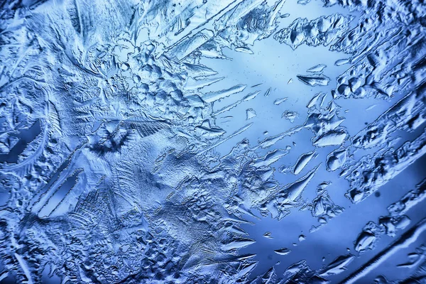 blue ice glass background, abstract texture of the surface of the ice on the glass, frozen seasonal water