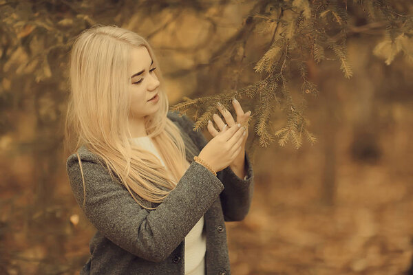 Blonde nature portrait autumn, beautiful young adult girl with long hair