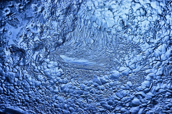 blue ice glass background, abstract texture of the surface of the ice on the glass, frozen seasonal water