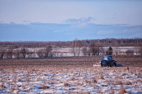 tractor in the field arable land winter agribusiness landscape seasonal work in a snowy field