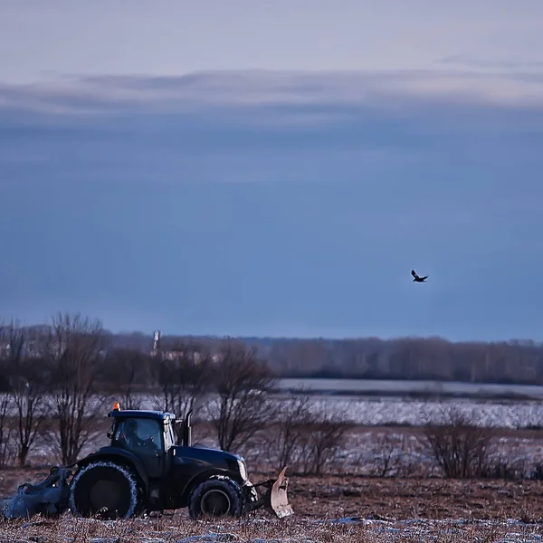 tractor in the field arable land winter agribusiness landscape seasonal work in a snowy field