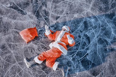 Noel Baba gölün buzunda kayıyor, kayıyor, yatıyor, Noel Baba eziği.