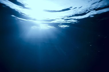 Suyun altındaki ışık huzmeleri, soyut deniz arka plan doğa ışınları bulanıklaşır