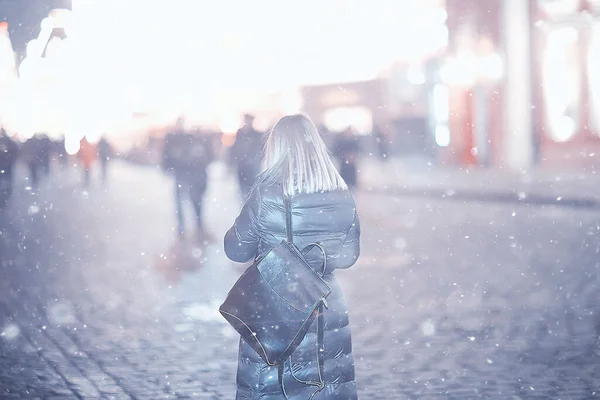 snowfall woman city christmas outside, city portrait in snowfall, young model posing in festive look