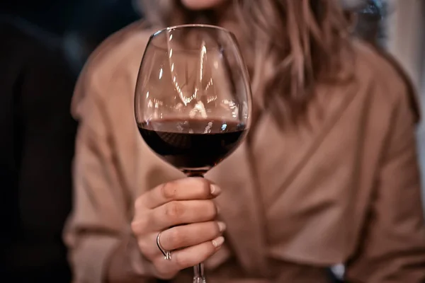 glasses of toast chin chin, hands with glasses of white wine in a street cafe