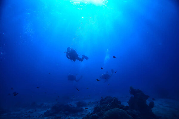 divers in the ocean, underwater sport active recreation in the deep ocean