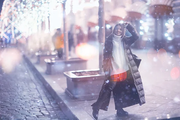 snowfall woman city christmas outside, city portrait in snowfall, young model posing in festive look