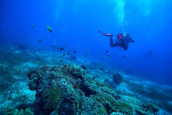 diver flippers view from the back underwater, underwater view of the back of a person swimming with scuba diving