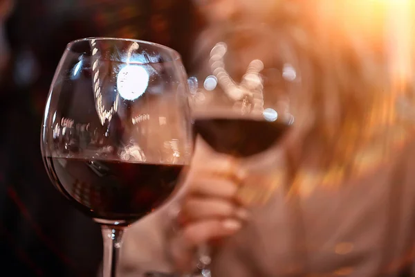 glasses of toast chin chin, hands with glasses of white wine in a street cafe