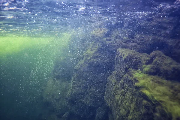 stones at the bottom underwater landscape, abstract blurred under water background