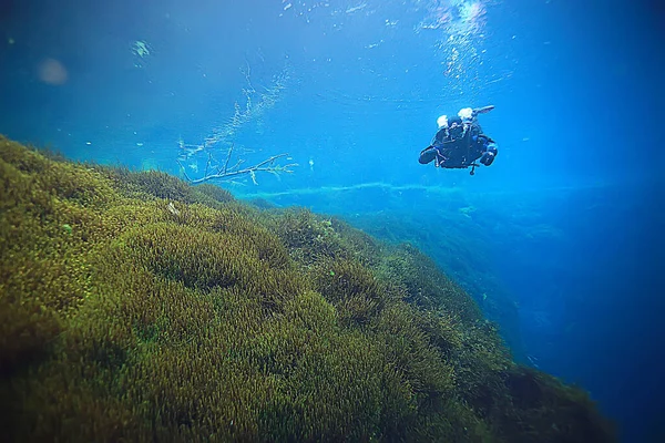 diver breathes air under water bubbles, releases gas, landscape underwater depth
