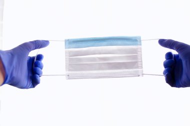 Eller tıbbi maske takıyor, virüs koruması konsepti, salgın hastalık, covid-19