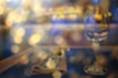 Lokantada bir akşam, bulanık bir arka plan, bokeh, alkol konsepti, bir barda şarap kadehi.