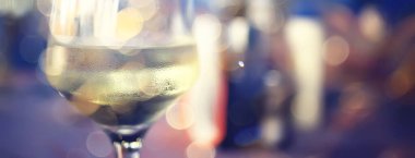 Lokantada bir akşam, bulanık bir arka plan, bokeh, alkol konsepti, bir barda şarap kadehi.