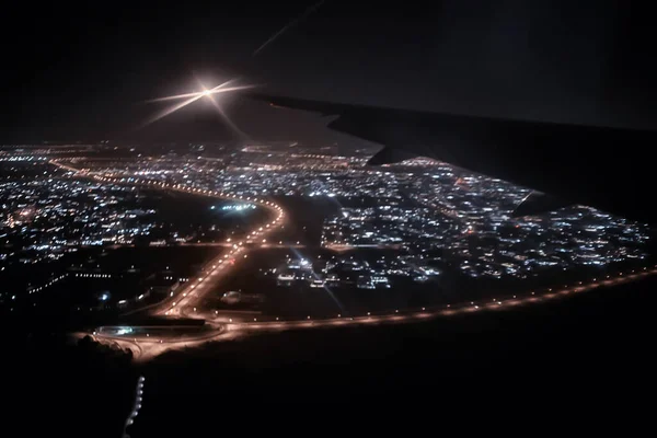 night view from the plane, night in the city lights from above view, flight trip