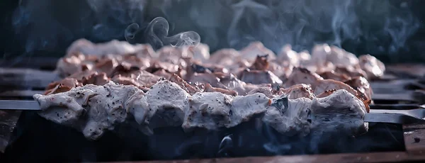 barbecue meat on coals, smoke smoked on iron skewers, fresh meat background