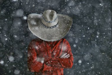 man in sombrero hat with brim, mexican style, latin america, snow cold winter christmas background clipart