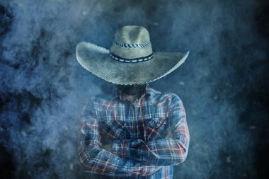 farmer hipster in a straw hat with brim in smoke smoking tobacco retro style wild west sambrero clipart