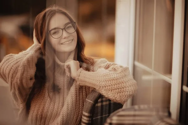happy girl autumn cafe sweater concept vision model with glasses posing
