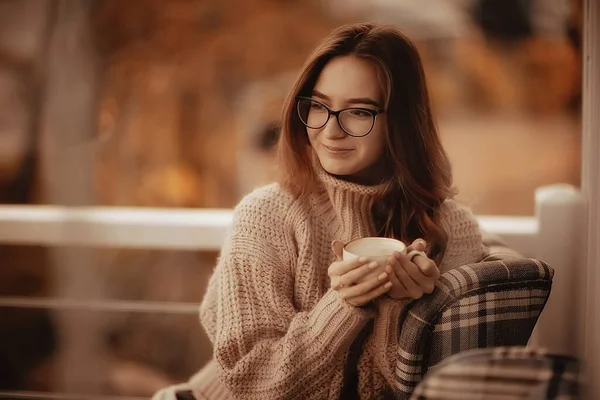 happy girl autumn cafe sweater concept vision model with glasses posing