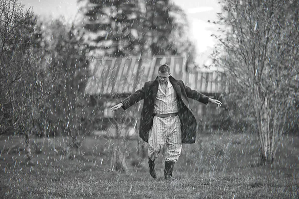 vintage man young village black and white, eastern europe style, retro coat and boots