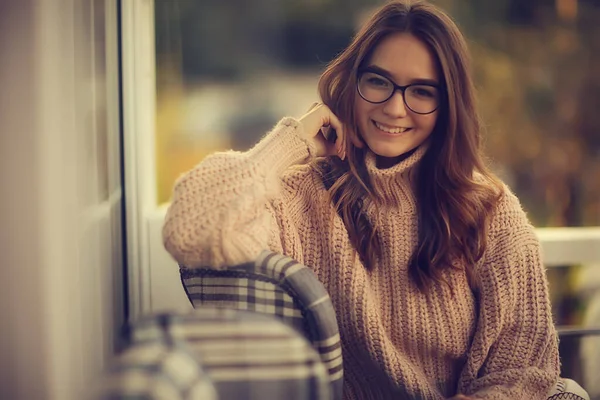happy girl autumn cafe sweater concept vision model with glasses posing