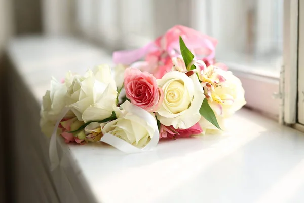 Close up view at bright wreath of roses on the windowsill Stock Image