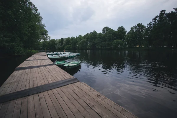 Boats rentals boat station a river and green trees on the background