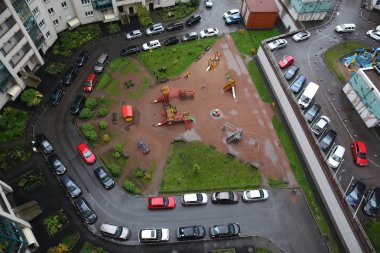 Parked cars in the courtyard of a block of flats in a new district of St. Petersburg. view from above clipart