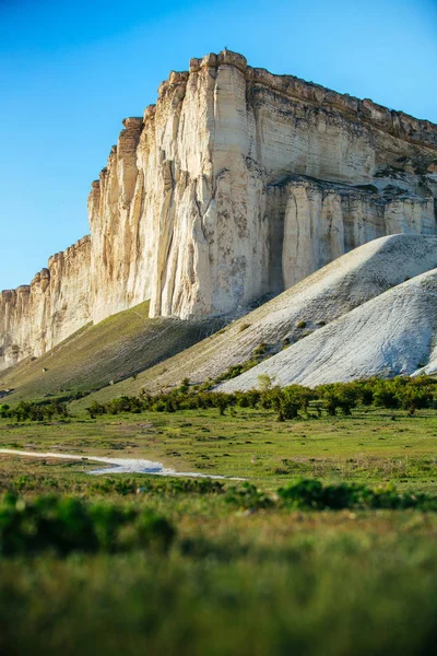 View of White rock or Aq Qaya on a Sunny summer day. Crimea. White limestone with a vertical cliff